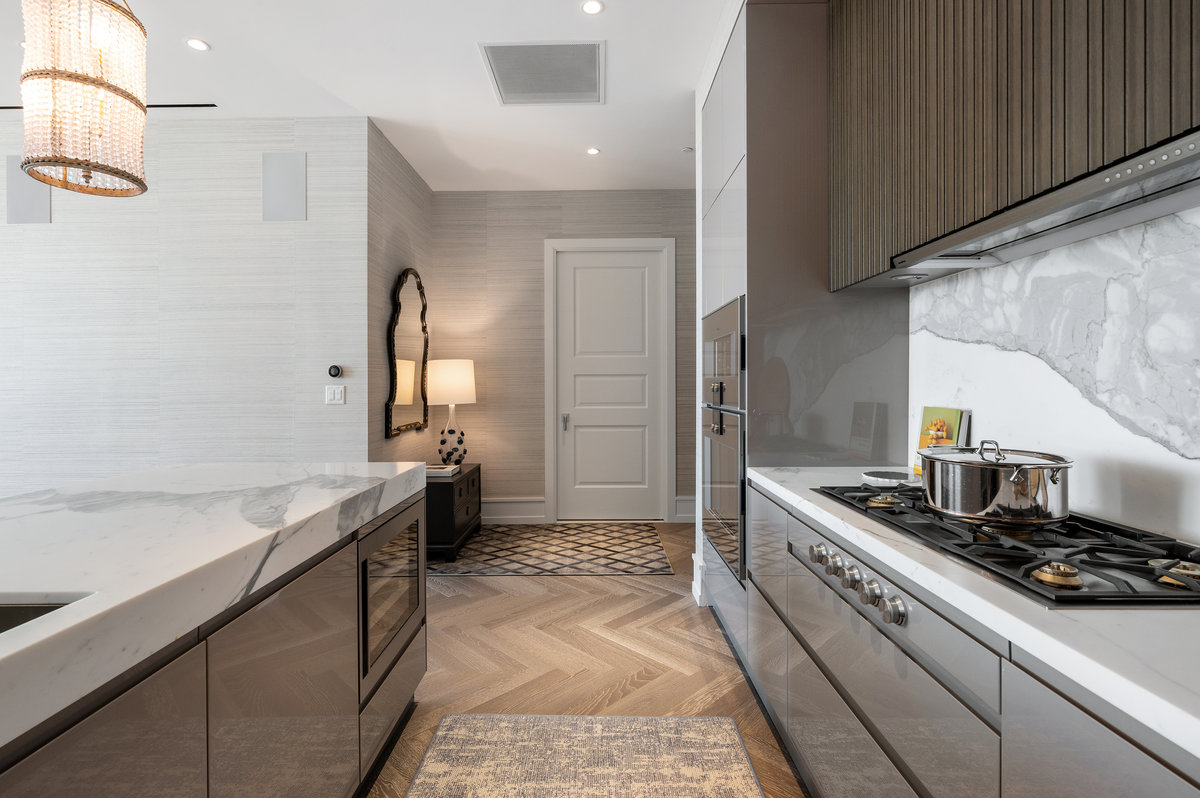 Open kitchen, ArcLinea cabinetry, Gaggenau appliances; laundry+pantry is behind the white door in the background of the image